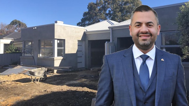 Deputy lord mayor Houssam Abiad (front), with one of his half-built properties (back).