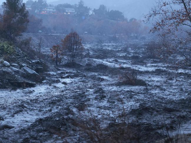 Caustic black water from the Eaton Fire rushes by in the Eaton Wash near Altadena, California, as an atmospheric river bring heavy rains on February 13, 2025. Residents of southern Californians are evacuating their homes because of the heavy rain and debris flows that threaten mudslides in areas recovering from wildfires. (Photo by David Swanson / AFP)