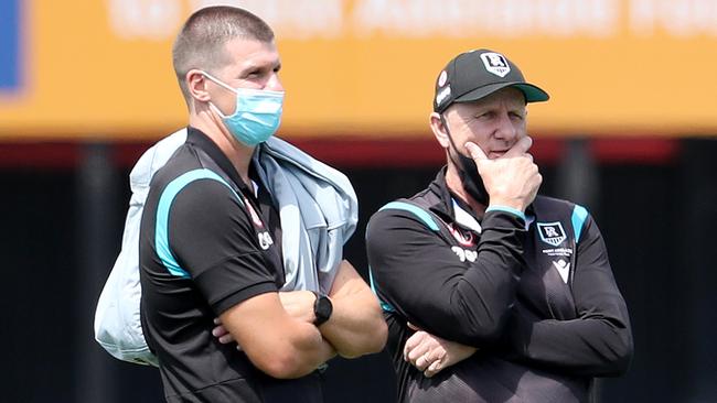 Ken Hinkley watches Port Adelaide training in March 2022, alongside Paul Stewart.