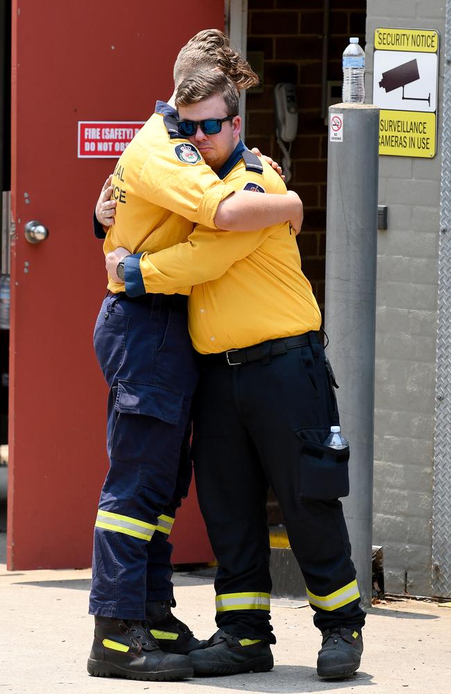 Members of the Horsley Park RFS are seen embracing at the Horsley Park Rural Fire Brigade in Horsley Park, NSW. Picture: AAP