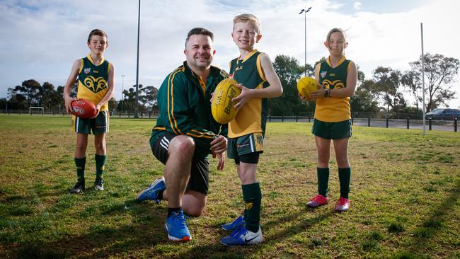 Under 9s coach Brett Fishpool with his son Darcy, 7, Rosie Munn, 8, and Hamish Wright, 9, at Marion Football Club. Picture: Matt Turner.