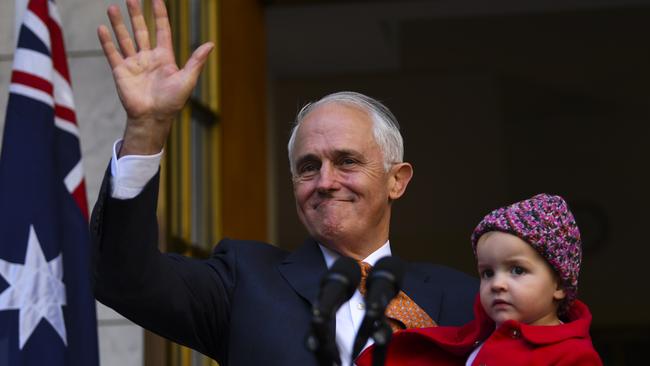 Outgoing Prime Minister Malcolm Turnbull’s last wave as he holds his granddaughter, Alice. Picture: AAP