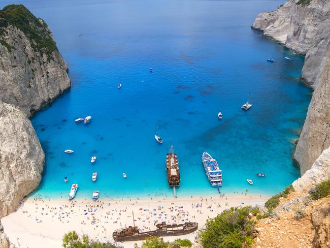 ESCAPE: Tourists and tourist boats  in the famous Navagio Bay, Zakynthos island, Greece. The beach of Navagio with the old shipwreck is one of the main tourism spots of Zakynthos island in Greece - beside of the wreck its the turquoise sea what makes this place so famous. Picture: istock