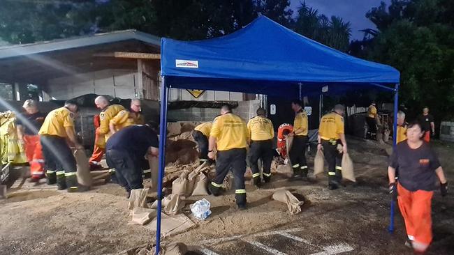 Tuggerah Rural Fire Service officers assist Wyong SES volunteers to fill sandbags ahead of expected storms. Picture: SES Wyong