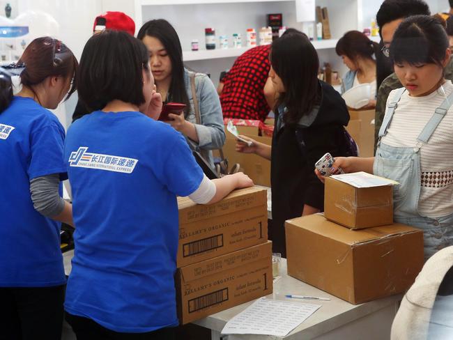 Grey market buyers sort boxes of Bellamy's Organic baby formula at Chinese courier company Chang Jiang in Melbourne.