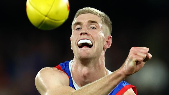 MELBOURNE, AUSTRALIA - APRIL 12: Tim English of the Bulldogs handballs during the round five AFL match between Western Bulldogs and Essendon Bombers at Marvel Stadium, on April 12, 2024, in Melbourne, Australia. (Photo by Quinn Rooney/Getty Images)