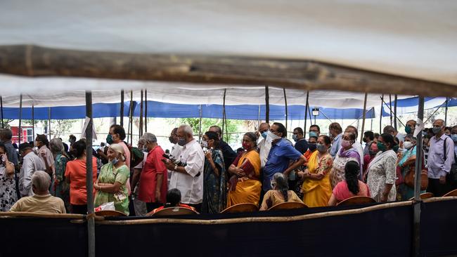 People line up to receive COVID-19 vaccinations in Mumbai.