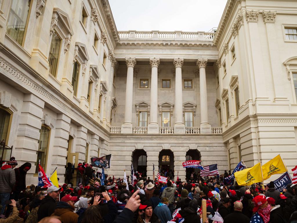 The mob broke windows and damaged property in the hope of stopping the Electoral College votes of several states from being approved. Picture: Jon Cherry/Getty Images/AFP