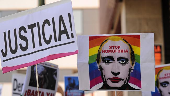 A protester holds up an image representing Russian President Vladimir Putin wearing lipstick during a protest against Russian anti-gay laws opposite the Russian embassy in Madrid, Spain. Picture: Getty Images