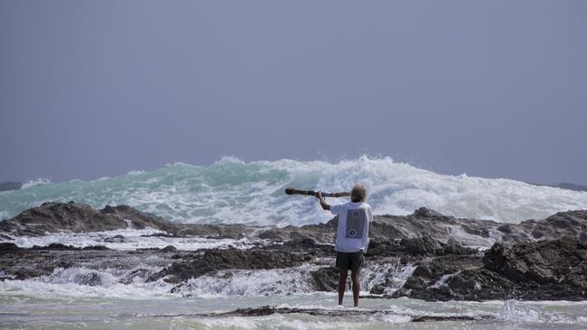 Snapper Rocks local Aboriginal identity Russell Corowa blessing the ocean on Sunday 2 January 2022. Picture: Jerad Williams