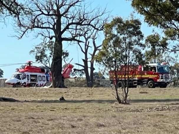 Two people have been rushed to hospital after a paraglider crashed into a paddock. Picture: ABC