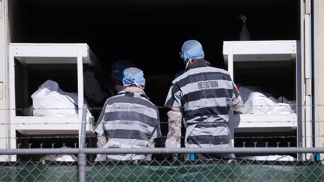 Low-security prisoners unload bodies at a temporary morgue in a carpark in El Paso, Texas, on Tuesday. Picture: AFP