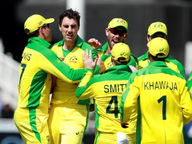 Pat Cummins is mobbed by teammates after taking a wicket against the West Indies.