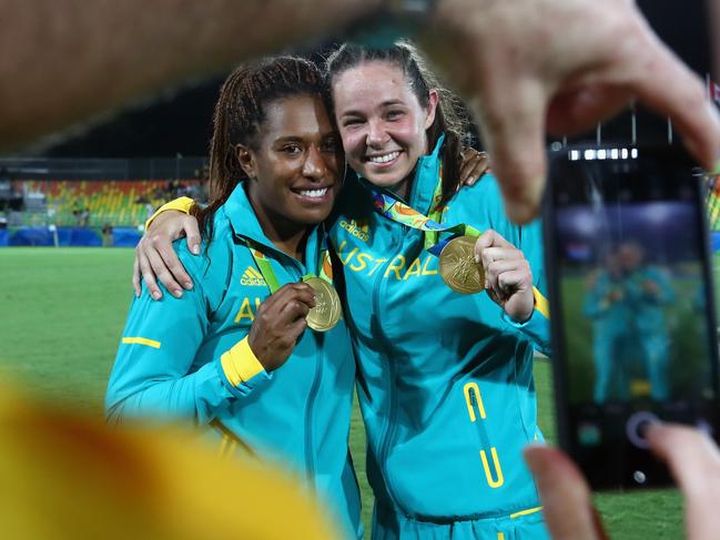 RIO DE JANEIRO, BRAZIL - AUGUST 08: Gold medalist Ellia Green (L) of Australia and her team mate Chloe Dalton pose with her Gold medal after the medal ceremony for the Women's Rugby Sevens on Day 3 of the Rio 2016 Olympic Games at the Deodoro Stadium on August 8, 2016 in Rio de Janeiro, Brazil. (Photo by Alexander Hassenstein/Getty Images)