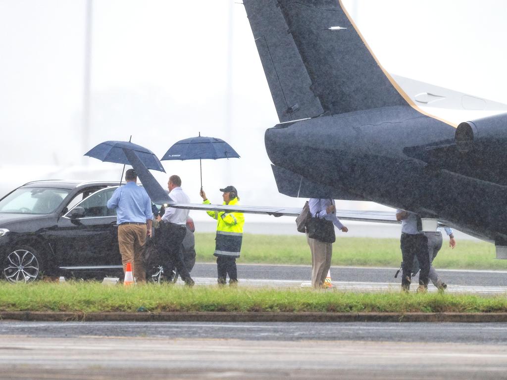 Police Minister Mark Ryan (blue shirt) and Premier Steven Miles (white shirt) arrive in Cairns on one of the private jets.