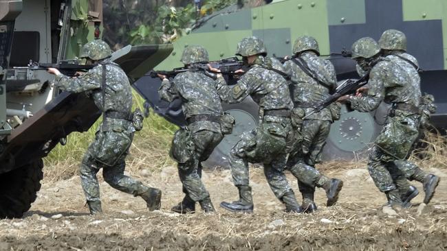 Taiwan special forces personnel walk behind an armoured personnel carrier during an annual military drill in Taichung, central Taiwan. Picture: AFP