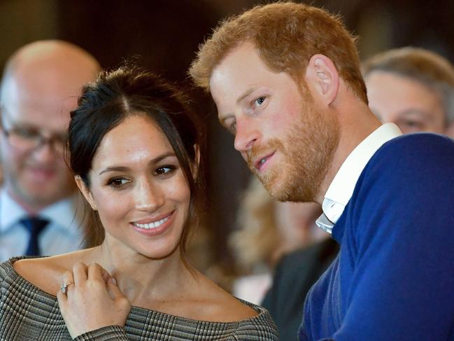 (FILES) In this file photo taken on January 18, 2018 Britain's Prince Harry and his fiancée US actress Meghan Markle watch a dance performance by Jukebox Collective during a visit at Cardiff Castle in Cardiff, south Wales on January 18, 2018, for a day showcasing the rich culture and heritage of Wales. Meghan Markle once struggled for roles but the US actress has now landed the biggest part of all as she prepares to marry Prince Harry on May 19, 2018 and become the newest face in Britain's royal family. / AFP PHOTO / POOL / Ben Birchall