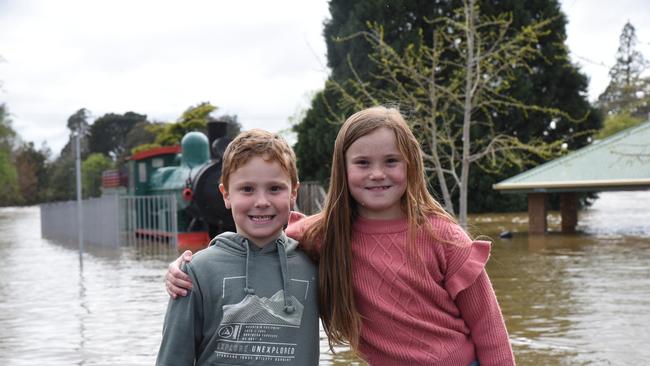 Blake and Madi How (kids wearing gumboots) at a flooded Deloraine Train Park. October 14, 2022.