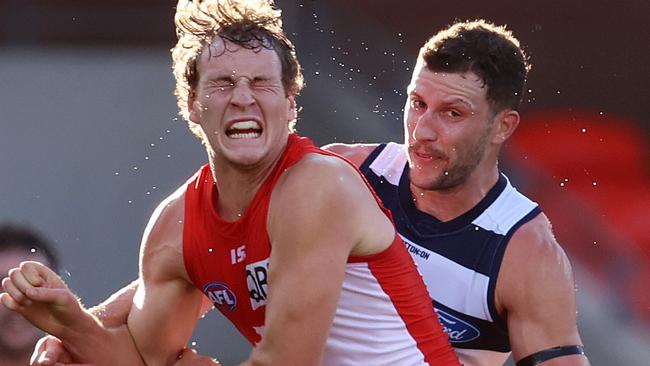 Jordan Dawson of the swans tries to spoil the kick of Sam Menegola. Picture: Michael Klein