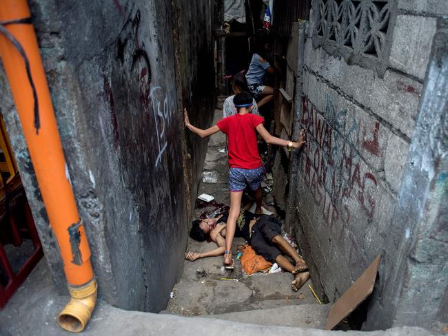 The dead body of Valien Mendoza, a suspected drug dealer, gunned down by unidentified assailants in Manila. Picture: AFP Photo/Noel Celis