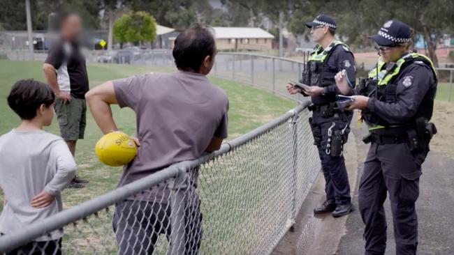 Police talk to people kicking the footy in a park to make sure the Chief Health Officer’s directions are not being breached.