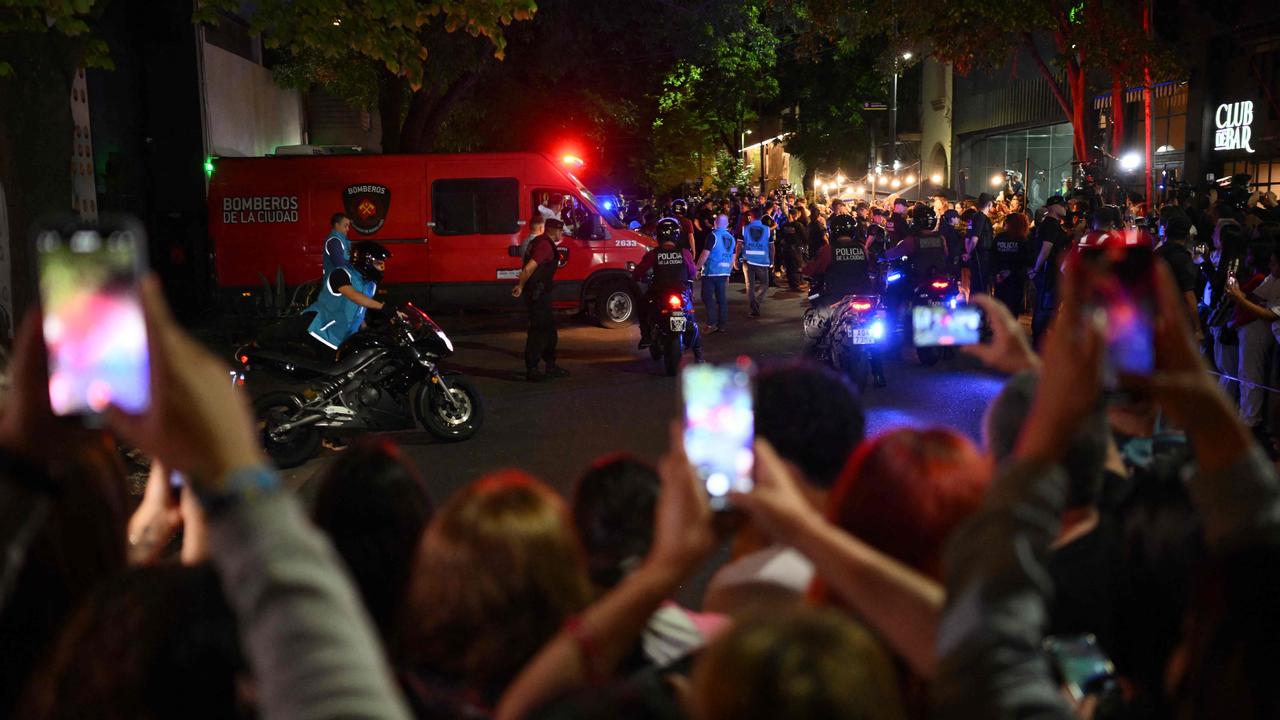 Police escort an vehicle carrying the body of Payne from the hotel. Picture: Luis Robayo/AFP