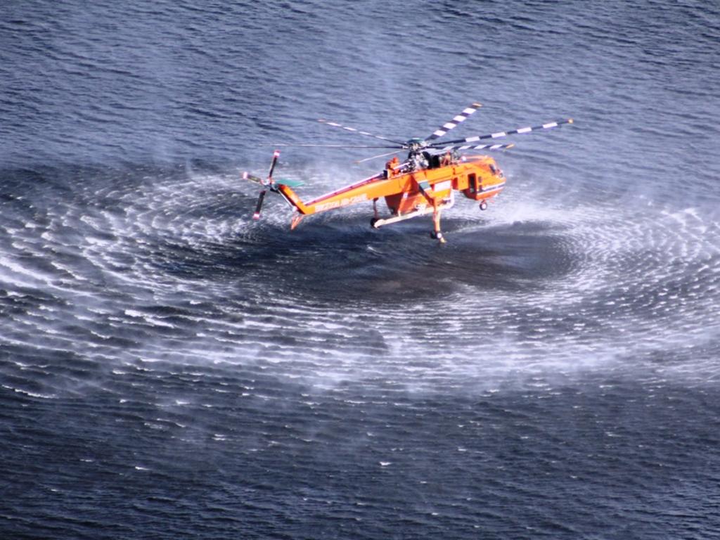 A water bombing helicopter takes on another water load from Lake Wartook during the Grampians fires last week. A total fire ban was in place but dry lightning strikes started the National Park fires. Picture: CFA