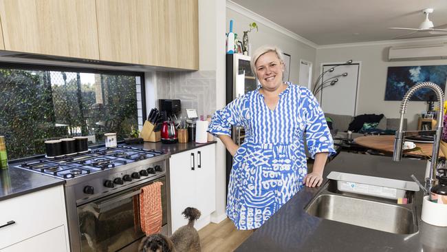 Kiah Coupland was assisted by her mother as a guarantor on her first home.  Pictured is Kiah inside her home with her dog Coco.