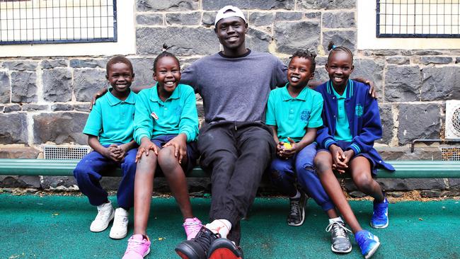 Engagement officer Wally Elnour with students Junior, Alady, Anei and Siena at Sacred Heart primary school in Melbourne’s Fitzroy yesterday. Picture: Aaron Francis