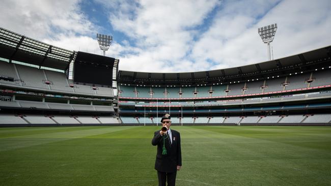 John Mansfield plays the bugle to an empty MCG on Anzac Day in 2020.