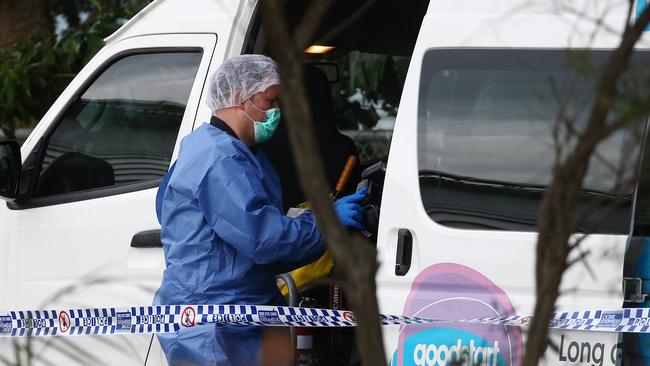 Police officers attend Hambledon State School at Edmonton, where a 3 year old was found dead in a Goodstart Early Learning Centre minibus at around 3:30pm on Tuesday. A police forensic officer inspects the van. PICTURE: BRENDAN RADKE