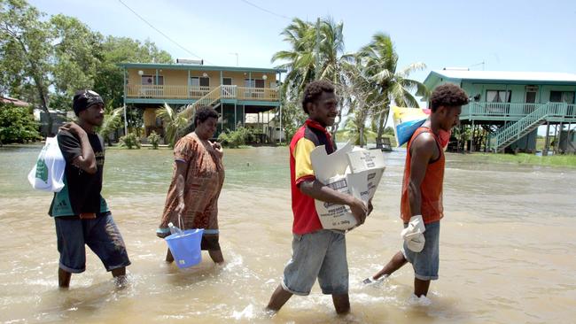 Saibai Islanders wade through floodwaters in 2010.