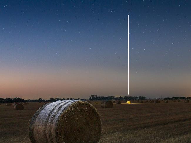 EMBARGO FOR TWAM 03 DECEMBER 2022. FEE MAY APPLY.  Photo of a hay bale, and light painting with a drone in Bacchus Marsh, VIC. Photo: Danielle Watson/Supplied