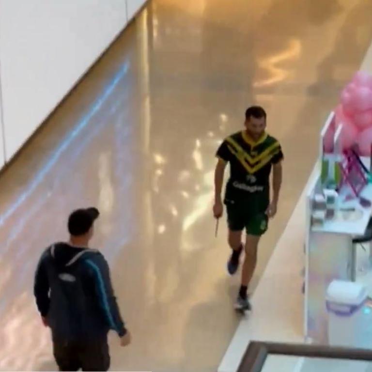 The attacker is seen stalking through the packed Westfield armed with a knife.