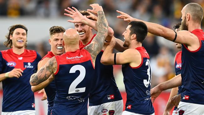 MELBOURNE, AUSTRALIA - APRIL 18: Mitch Brown of the Demons is congratulated by team mates after kicking a goal during the round five AFL match between the Hawthorn Hawks and the Melbourne Demons at Melbourne Cricket Ground on April 18, 2021 in Melbourne, Australia. (Photo by Quinn Rooney/Getty Images)