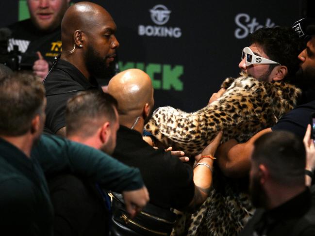 Dillon Danis (right) is held back after clashing with Paul at a press conference in England last year. Picture: Getty Images