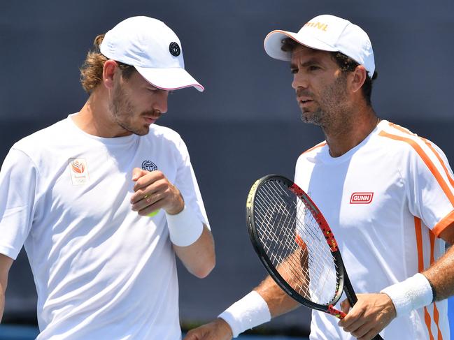 Netherlands' Jean-Julien Rojer (R) and Netherlands' Wesley Koolhof talk during their Tokyo 2020 Olympic Games men's doubles first round tennis match at the Ariake Tennis Park in Tokyo on July 24, 2021. (Photo by Tiziana FABI / AFP)