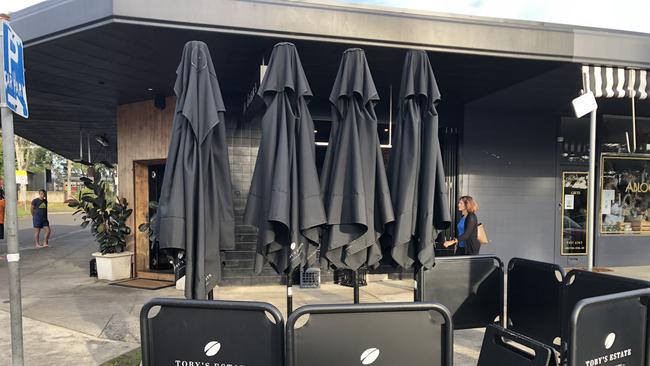 The packed up umbrellas outside the popular Mr Grigor's cafe and restaurant at Allambie Heights, which closed on March 8. Picture: Jim O'Rourke