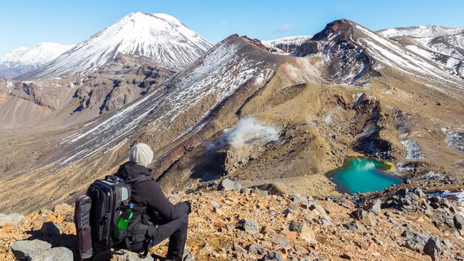 ESCAPE: NEW ZEALAND .. John Corbett story .. Hiker looking at volcanic landscape, New Zealand. Picture: Getty