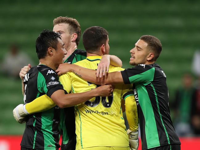 MELBOURNE, AUSTRALIA - MARCH 14: Ryan Scott of Western United (C) is embraced by Tomoki Imai of Western United and Dylan Pierias of Western United as they celebrate victory in the A-League match between Western United and the Brisbane Roar at AAMI Park, on March 14, 2021, in Melbourne, Australia. (Photo by Graham Denholm/Getty Images)