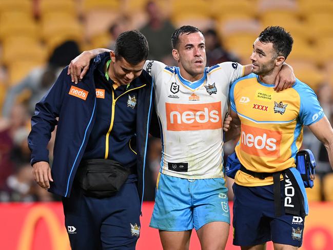 Corey Thompson of the Titans is helped from the field after injuring his ankle. Picture: Bradley Kanaris/Getty Images