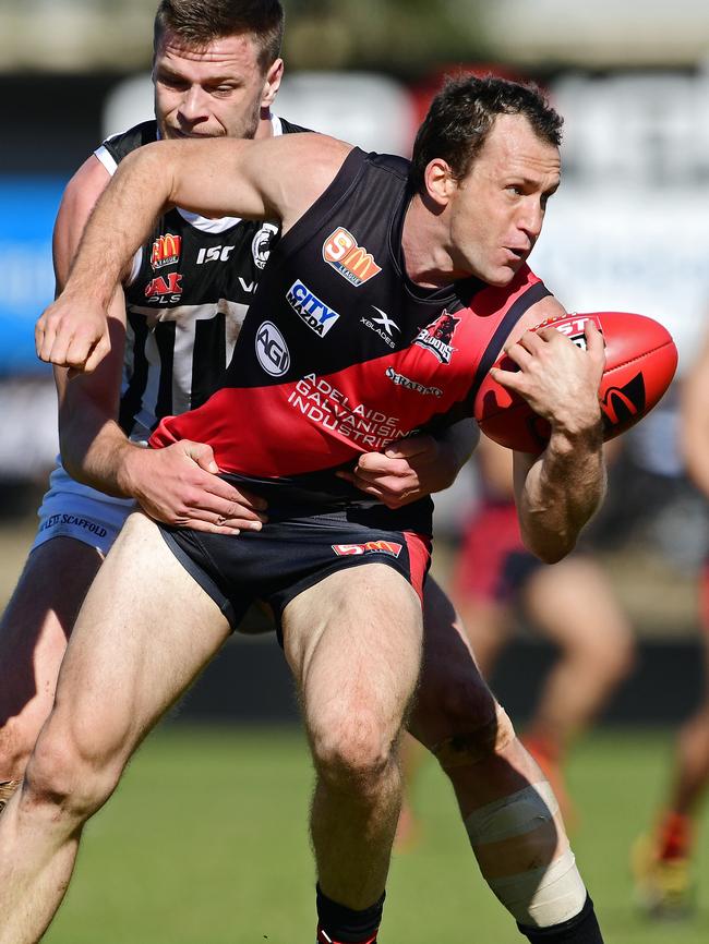 West's Jason Porplyzia tries to escape the clutches of Port's Peter Ladhams on Saturday. Picture: Tom Huntley