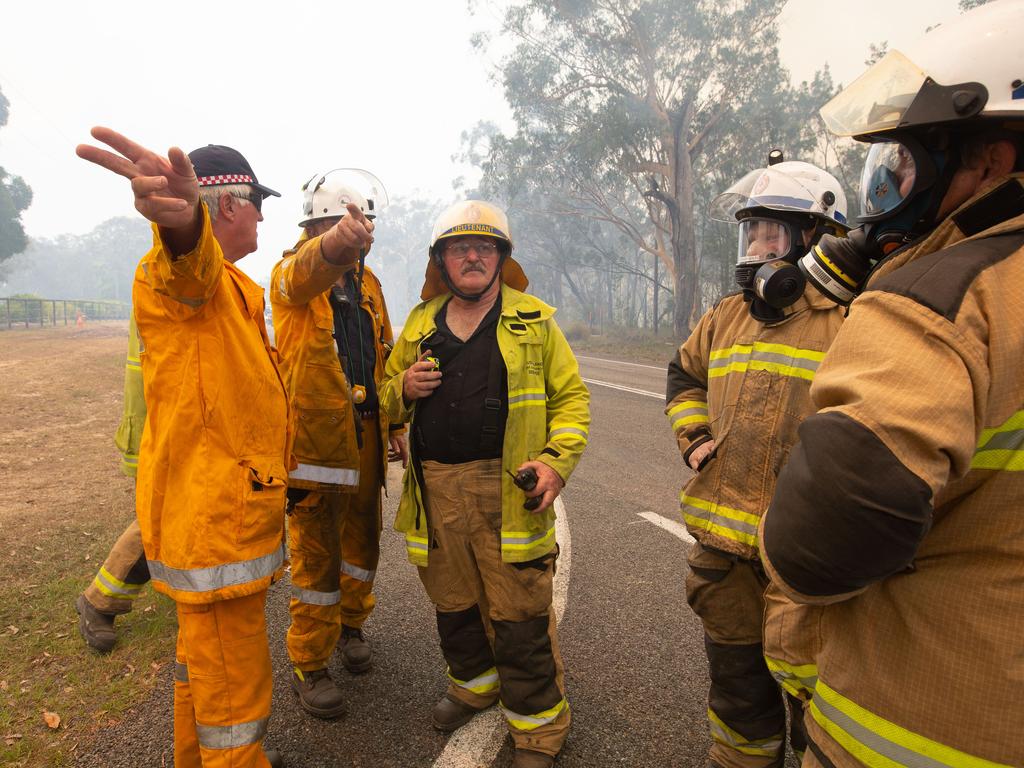 Firefighters near fires at Lake Cooroibah Road and Jirrimah Crescent in Cooroibah in Noosa Shire. Picture: AAP Image/Rob Maccoll