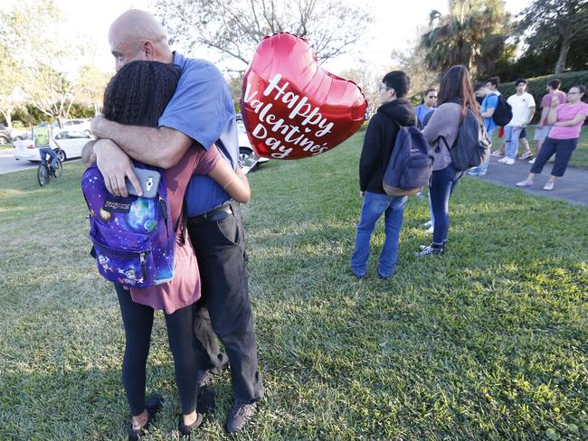Family member embrace following a shooting at Marjory Stoneman Douglas High School. Picture: AP