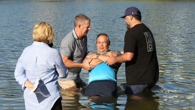 Tom Tate is getting baptised at Evandale Lake during a combined churches service. Pastor Sue Baynes and helpers Marshall Gray and Rodger Baynes. .Picture Mike Batterham