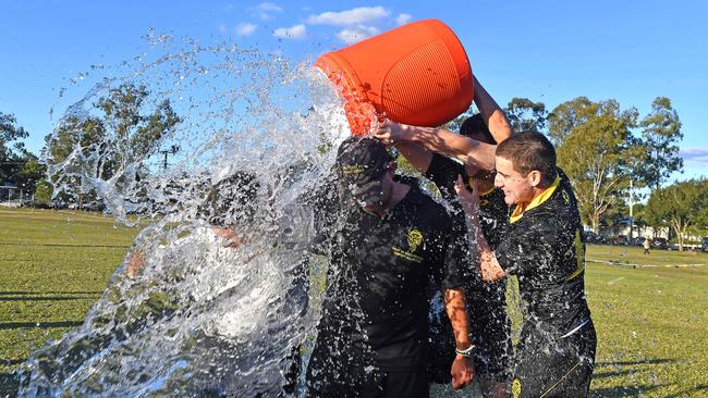 Coaches get the water treatment from some of the players St Laurence's College crowned AIC champs. Saturday June 12, 2021. Picture, John Gass