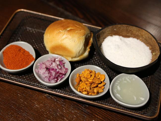 Tableside coconut sambal with red chilli and red onion.