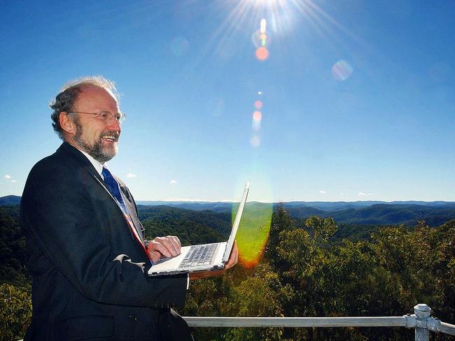 Broadband expert Paul Budde with his laptop on top of a mountain at Bucketty. Picture: Peter Clark