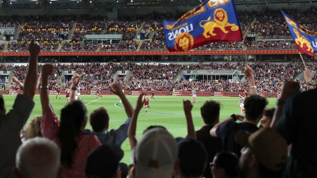 Fans cheer during the AFL preliminary final match between the Brisbane Lions and the Geelong Cats at The Gabba on October 17. Picture: Jono Searle/AFL Photos/via Getty Images.