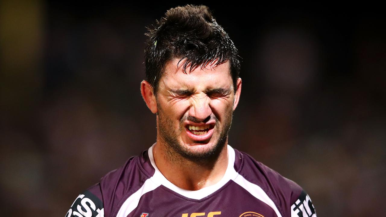 Matt Gillett of the Broncos grimaces after suffering a neck injury. (Photo by Mark Kolbe/Getty Images)